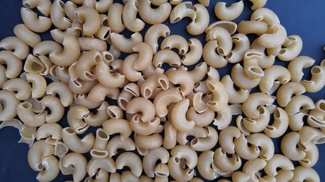 Slow Motion Pasta Food Preparation Clip , top down view of elbow pasta