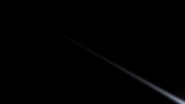 Glowing Light Streak and Lens Flare Motion Trail Moving Diagonally Across Dark Background