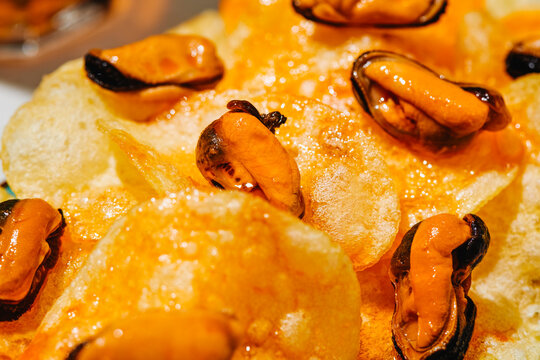 close-up of mussels on escabeche-soaked chips