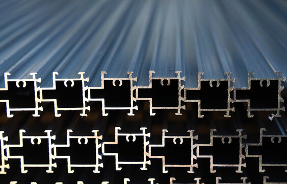 Stacked thermal break aluminum alloy window profiles stored in factory workshop