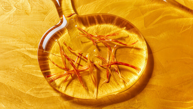Golden saffron liquid tea splash background