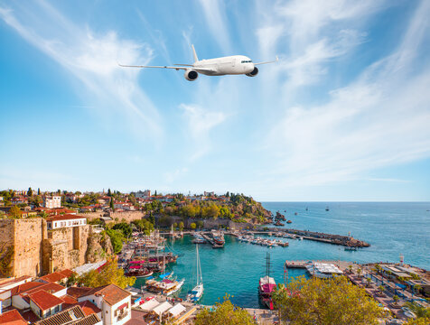 White an air plane fly over the Old Town Kaleici - Antalya, Turkey
