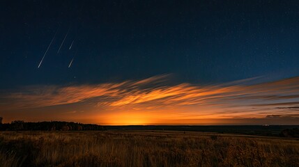 Obraz premium Brilliant meteor shower streaks across a twilight sky above fiery clouds and fields