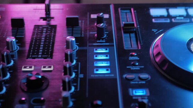 Professional DJ Mixer with Headphones Close Up on Digital Audio Control Board and Music Production Technology Workspace