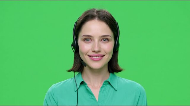 Customer service representative with headset smiling against green screen background