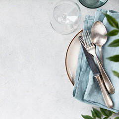 Obraz premium Elegant Table Setting with Vintage Cutlery and Greenery
