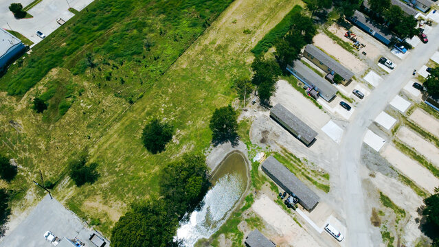 Expansive grassy fields border southern neighborhood perimeters near localized water retention features. Aerial imagery documents grassland transitions defining zoning in New Braunfels, TX