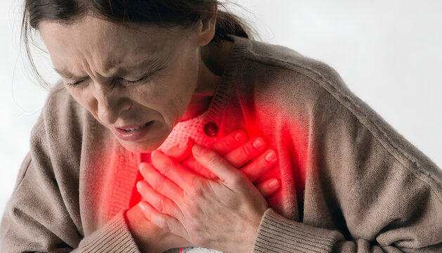 Chest Pain Concept &ndash; Woman Holding Chest with Severe Heart Discomfort