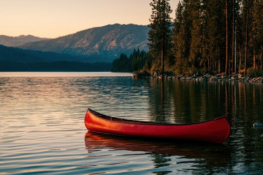 Red canoe on Cooper Lake at sunset, a tranquil lakeside scene near Cle Elum