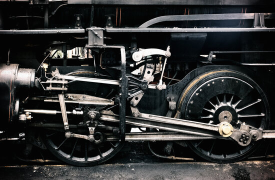 Steam engine's undercarriage gleams with aged metal