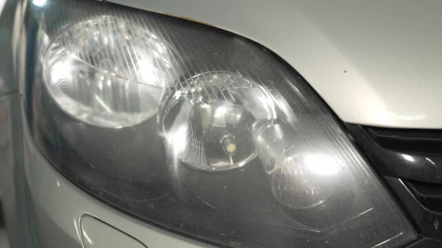 A close-up shot of a car front headlight lamp assembly.