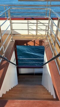 Vertical video of a peaceful ocean view from a luxury yacht, capturing calm waters, elegant travel atmosphere and relaxing Mediterranean lifestyle during a premium sailing experience.