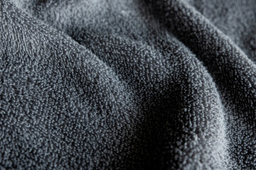 Dark Grey Microfiber Fabric Texture Background with Soft Waves © chaophrayaart