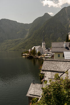 Hallstatt Nature Village on Lake Alpine Mountains and water in Austria. Old Church. Autumn hill fall background. Foggy day