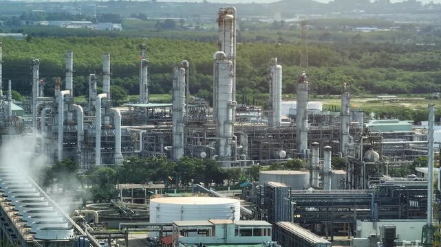 Drone view of cooling tower steam clouds above heavy industry, emphasizing thermal energy control, industrial water treatment, and the balance between manufacturing and environmental protection. 4k.
