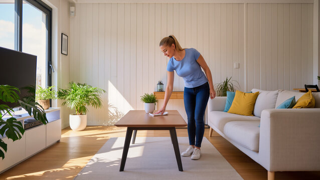 Young Woman Cleaning Living Room