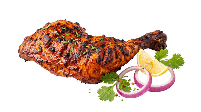 Grilled chicken leg quarter with tandoori spices, roasted chicken drumstick and thigh, spicy poultry dish with red onion and lemon on white background