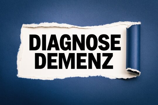 Black text diagnose demenz written under torn blue paper