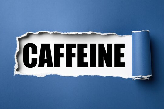 Black text caffeine written under torn blue paper