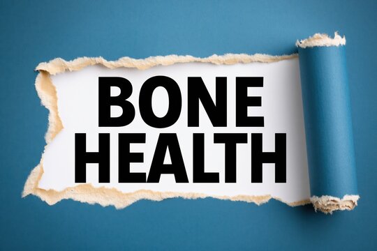 Black text bone health written under torn blue paper