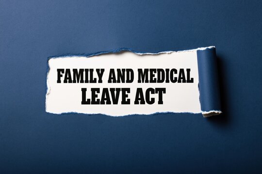 Black text family and medical leave act written under torn blue paper