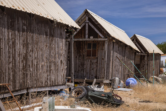 Derelict huts and old machinery, Culatra Island, Ria Formosa Natural Park, Olh&atilde;o, Algarve, Portugal