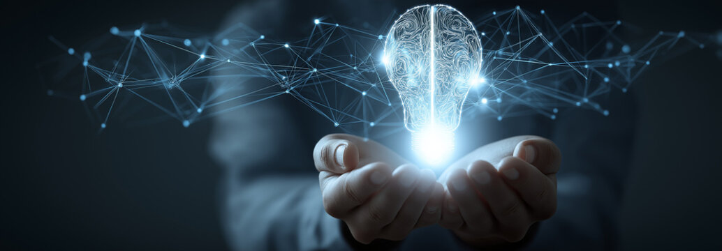 person's hands are cupped together, holding a luminous digital lightbulb. the lightbulb's design is split