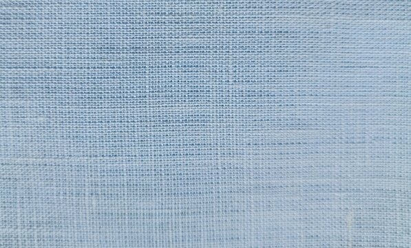 Close up of light blue fabric with a loose, mottled weave featuring thicker horizontal threads for a ribbed, striped effect.
