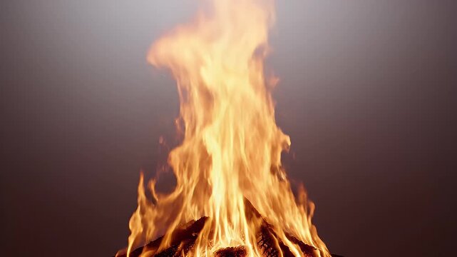 Intense flames engulf stacked logs, casting a warm glow against a smoky background