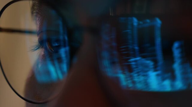 An urban planner wearing eyeglasses studies a digital city skyline on a futuristic display, symbolizing smart city planning, urban development, digital infrastructure, and sustainable innovation. 4k.

