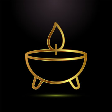 Golden traditional indian oil lamp diya with flame on black background for celebrations.