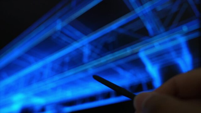 An architect uses a stylus to review a digital building blueprint on a futuristic touchscreen, symbolizing architectural design, BIM planning, engineering precision, and construction innovation. 4k.
