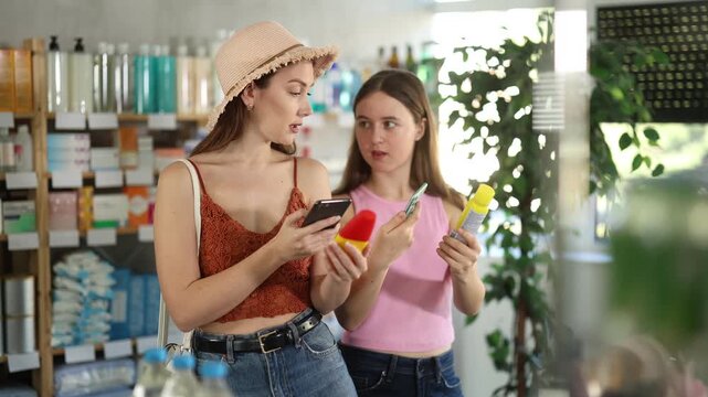 Mother and daughter carefully scan the barcode of the repellent on their mobile and read detailed instructions for use and how to spray correctly . High quality 4k footage