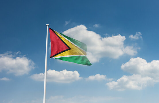 Guyana flag waving in beautiful sky.