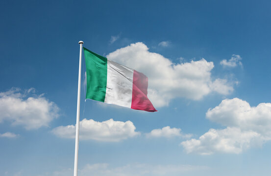 Italy flag waving in beautiful sky.