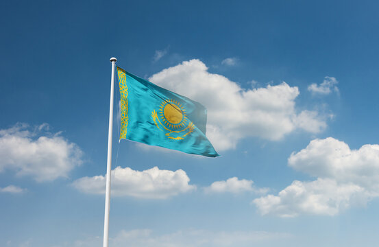 Kazakhstan flag waving in beautiful sky.