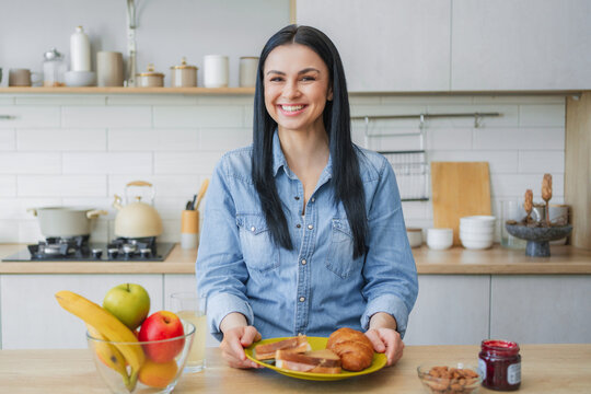 Happy woman eating sandwich in modern kitchen, homemade breakfast, nutritious meal, fresh ingredients, healthy lifestyle, self care and comfortable home concept