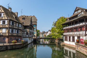 Naklejka premium Strasbourg, France, 7.31.2026; Panorama from the popular Petite France district is known for its cobblestone streets, canals, and well-preserved half-timbered houses, including the Maison des Tanneurs