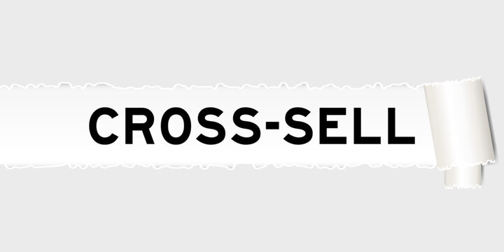 Ripped gray paper background that have word cross sell under torn part