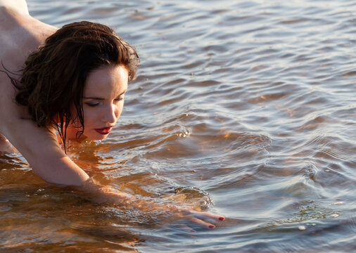 Nude Woman Reaching Water Surface