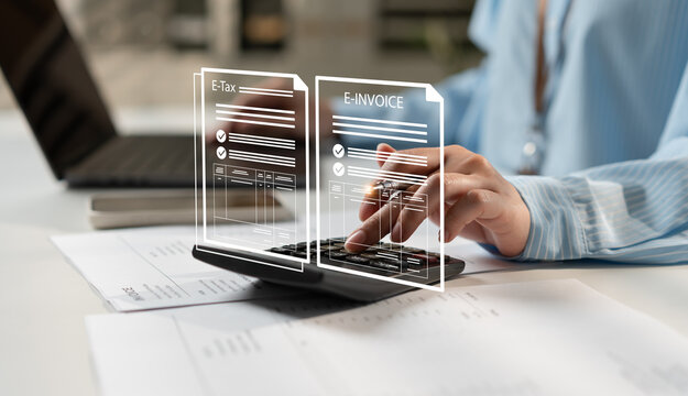 Businesswoman managing e-tax and e-invoice documents with calculator, laptop and financial paperwork, showcasing digital accounting, tax compliance, electronic billing and modern office workflow.