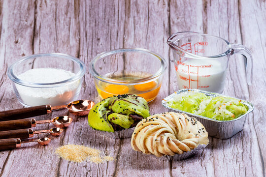 Assorted Homemade Bread Collection with Baking Ingredients on Rustic Wooden Background