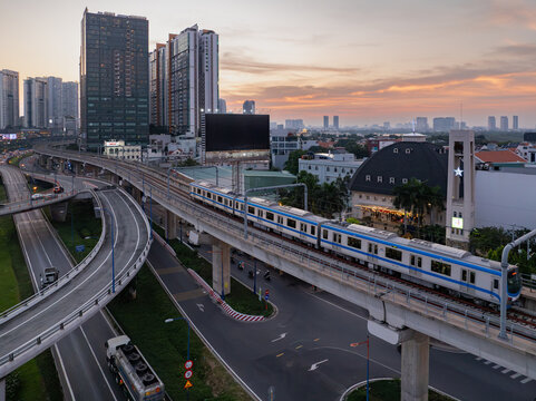 January 5, 2025: Ho Chi Minh City's first metro line passes through a modern skyline at sunset in Ho Chi Minh City, Vietnam.