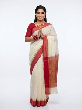 Indian woman in traditional saree greeting with namaste isolated on white background