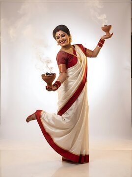 Bengali woman performing dhunuchi dance during durga puja festival
