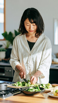 Beautiful Asian Woman Preparing Fresh Vegetables in a Bright Modern Kitchen