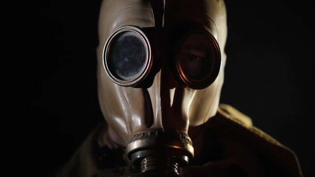 Cinematic portrait of person wearing vintage soviet gp5 gas mask in dark smoky room for post apocalyptic concept.