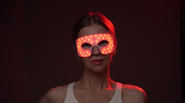 woman wearing infrared light eyes therapy mask. Red and infrared light therapy eye mask.  biohacker theme professional  skin care video footage