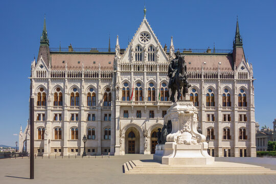 Iconic Hungarian Parliament Building and Andr&aacute;ssy Equestrian Statue at Kossuth Square, Budapest. Grand Neo-Gothic architecture