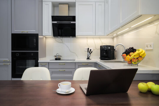 Laptop on kitchen table at home